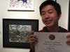 Willy Chan poses with his artwork.