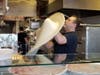 The pizza began the usual way, by hand tossing the dough. 