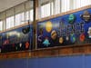 Ten new murals adorn the Washington School gymnasium.