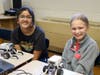 Roosevelt 7th grader Aashma Pant (left) and Edison 6th grader Jenny Butler team up to design and build robots at STEM Camp.