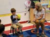 As part of Week of Respect activities, Lincoln School teacher Kristin Bartok and preschooler Luke Hamilton begin the “Compliment Game,” passing the ball, along with a kind word, around the circle.