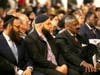 Jewish, Muslim and Christian clergymen sit together at the Unity Rally