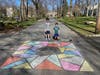 Jody Gordon and her kids put down several colorful drawings in Chatham. 