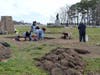 Volunteers in February of 2013 are shown digging "test units" on a 21' by 17' foundation 