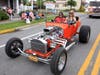 Gina M. and Kim B. having fun driving antique 1927 Ford T-Bucket roadster in festival parade. A roadster is considered an open two-seat car with emphasis on sporting appearance or character.