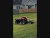 Case International 235 tractor w/ a weighted pull behind aerator provides aeration/over seeding as a critical step in producing a good stand of grass as it helps by reducing soil compaction and allows improved air exchange between the soil and atmosphere.