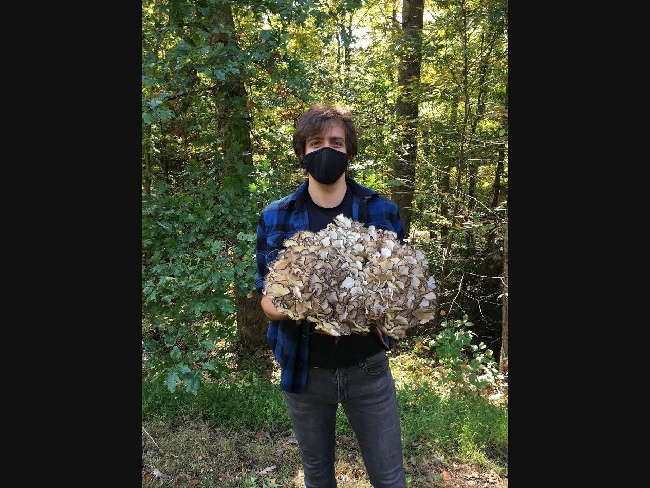 Griffin Kalin, IAIS Educator and  Traditional Skills Expert holding Hen of the Woods