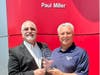 Scott Cairo (l), Nissan Senior Operations Manager, presents Paul Miller with a 30th Anniversary Award commemorating 30 years as a Nissan Dealer.

