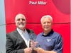 Scott Cairo (l), Nissan Senior Operations Manager, presents Paul Miller with a 30th Anniversary Award commemorating 30 years as a Nissan Dealer.