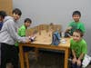 "Team Attack" created a game where soldiers dodged ping-pong ball projectiles.  L to R (team members in green):  Vivaan, player Avi, Bradlee, Samuel.