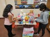 Athens High School Project Lead members Divya Thirukumaran, junior (left), and sophomore Shreya Bala, share some of the donations collected by the service club to benefit The Bottomless Toy Chest in Birmingham.