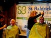 "Shavees" Mike Norton and Bob Slingo getting their heads shaved. 