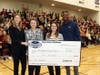 Issaquah Middle School teacher Traci Brewster (2nd left) received a $2,000 donation for classroom books and supplies from Symetra as part of her award.