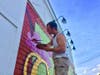 Pictured here painting the now iconic mural in Dedham's historic Oakdale Square, Artist/Muralist Sal D'Antona is leading the art restoration of the little libraries across Dedham