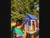Ava D'Antona hard at work repainting the little library in the Manor neighborhood. 