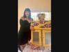 East Dedham Native and Artist Sarah Edson poses with her little library entitled Victorian Roses, which she repainted in her studio in Maine where she now resides. 