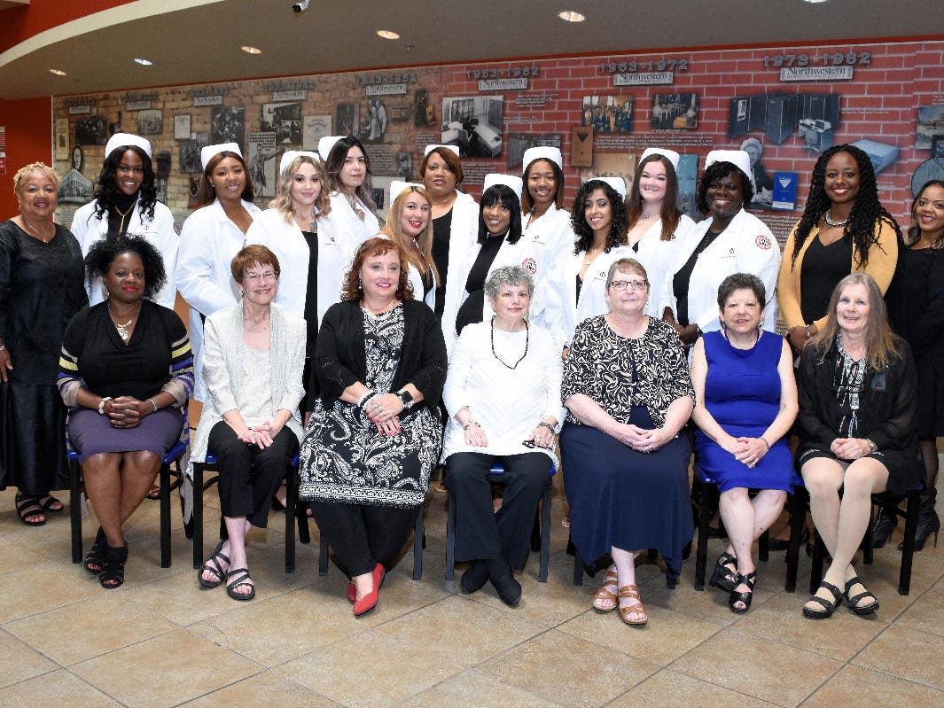 Northwestern College’s September 2019 Nursing Graduates in their white coats at their Pinning Ceremony, pictured along with their Nursing Faculty and Administration. 