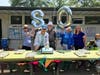 No birthday celebration is complete without cake and balloons. Gathered around the cake for the Mary Barness Tennis and Swim Club are (Left to right) Township Supervisors Carol Baker, Ruth Schemm, Fred Gaines, Shirly Yannich and Eileen Albillar.