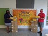 LaVonda Daniels, Principal at William Davis Elementary, accepts a donation of 240 school supply kits from Tom Pagan, manager of the Staples store in Warrington. 