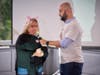 Tara Murphy, of Archbishop Wood High School speaks with Marc Farzetta, sports-radio personality and host of the Farzy Show podcast, before showing some love to a pot-bellied pig named Raines, at TruMark Financial’s Feed-Or-Kiss-A-Pig event. 