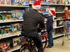 A Warrington Township police officer coasts in the aisle while a student picks out a gift at the fifth annual “Shop with a Cop” event on December 7 at the Warrington Walmart Supercenter.