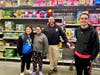 Warrington Township police officer and students take a break from shopping to pose for a photo during the fifth annual “Shop with a Cop” event. 