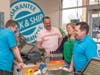 Reggie Rytter (Right) and a staff member enjoy a laugh with guests at the grand opening of The UPS Store in The Shops at Valley Square on Wednesday, April 5.  