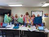(Left to Right): NOVA Counselors Jee Soo Lee, Kevin Keller, Beth Hafft, Ashley Foley, Ray'ven Hudley, Sydney Finsel, and Jackie Carnation proudly display the fleece tie blankets donated by Women of Shir Ami that will be provided to NOVA clients.