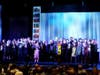 Cast members sing "Rise Above and Go Beyond" at curtain call