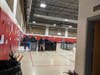 Paras unpack Chromebooks in the school gym