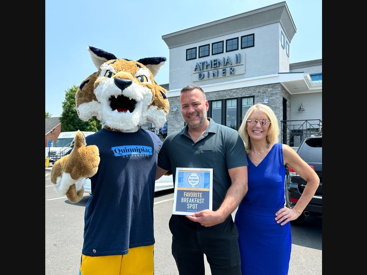North Haven’s Athena II Diner was one of the local businesses to receive a Quinnipiac University 2023 Student Choice Award. Pictured, from left, are Boomer the Bobcat, diner owner Christos Stefanis, Bethany Zemba