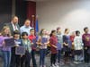 Christopher Montini and Board Chair Jeff Litke pose with students recognized for leadership. 