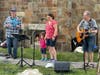 Melrose’s Howie Newman (right) was joined by his daughter, Jen, and granddaughter, Hannah, for a song at the June 23 Pantry of Hope fundraiser. Joe Kessler is on the fiddler.