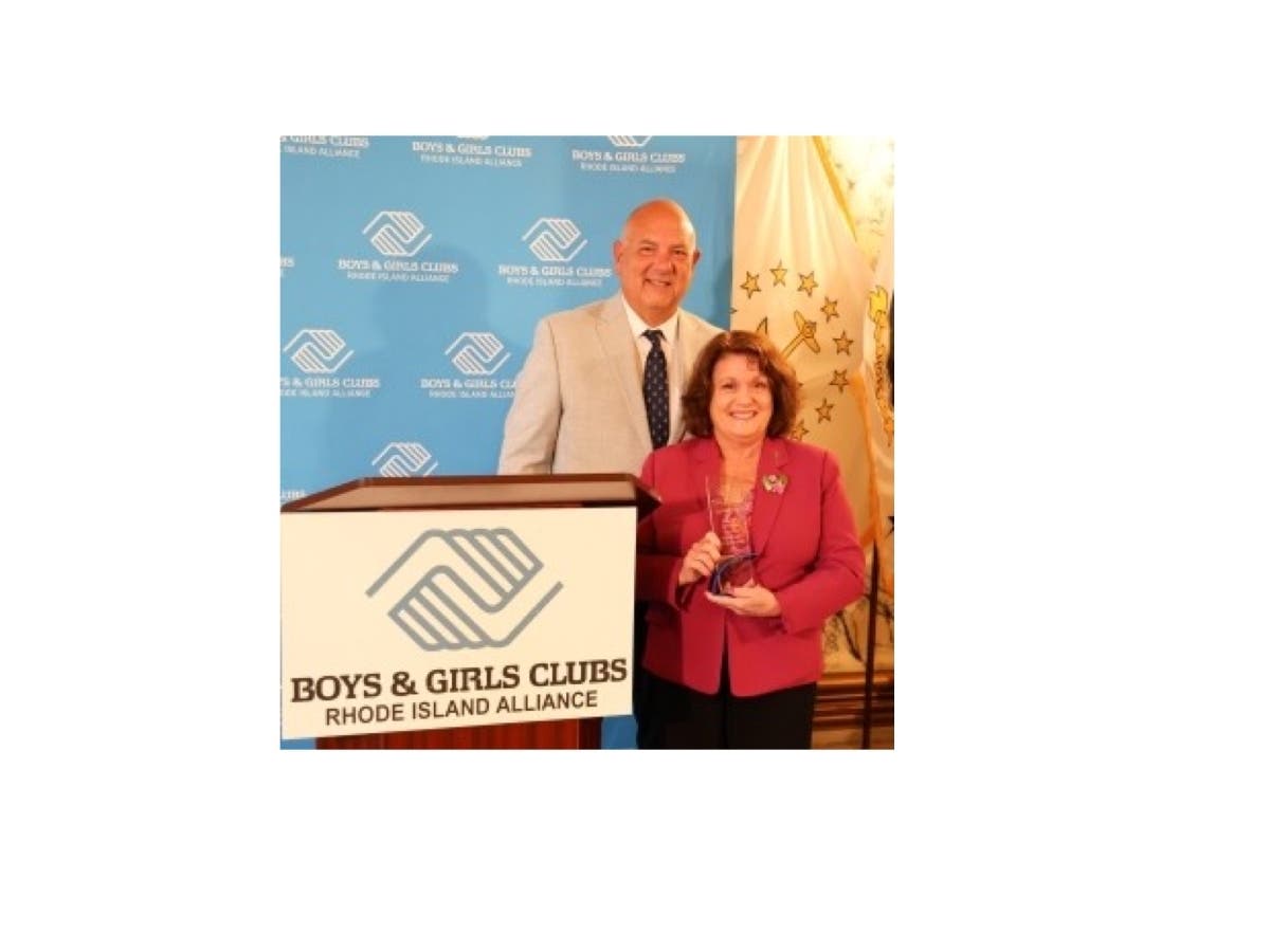 Rhode island state Rep. Mia A. Ackerman receives her award from Boys & Girls Clubs of Northern Rhode Island President Gary Rebelo.