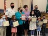 Back Row: Fire Chief Wheeler, Mayor Bury, Chamber President Eileen Kerlin Walsh, Police Chief Vittorio; Front Row Left to Right: Michael Wos, 1st-Fire, Jimena Alvarez, 3rd-Fire, Aubrey Imala, 2nd-Fire, Fatima Alkhulaqi 1st-Public, Vincent Rodriguez 2nd-Pu