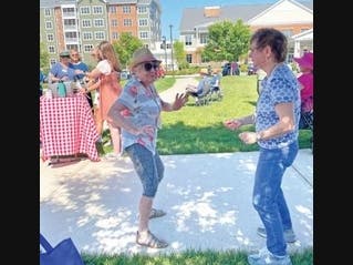 Residents Mary Kedian (left) and Frances O’Connor regularly gather for music, friendship, and refreshments outside at Ashby Ponds.