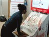 A young girl tries out the new Hands-Only CPR training kiosk at the LAX Tom Bradley International Terminal