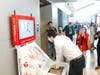 Zach Ginngold, whose life was saved by CPR, checks out the Hands-Only CPR kiosk unveiled at LAX on June 11