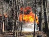  A neighbor came home to walk her dogs and found the neighboring garage engulfed in flames.