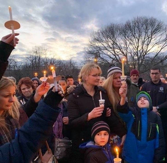 Thomas Valva's mother Justyna Zubko-Valva and his brothers at a Center Moriches vigil in his memory.
