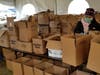 Volunteers help to distribute food to Shinnecock tribal membes.