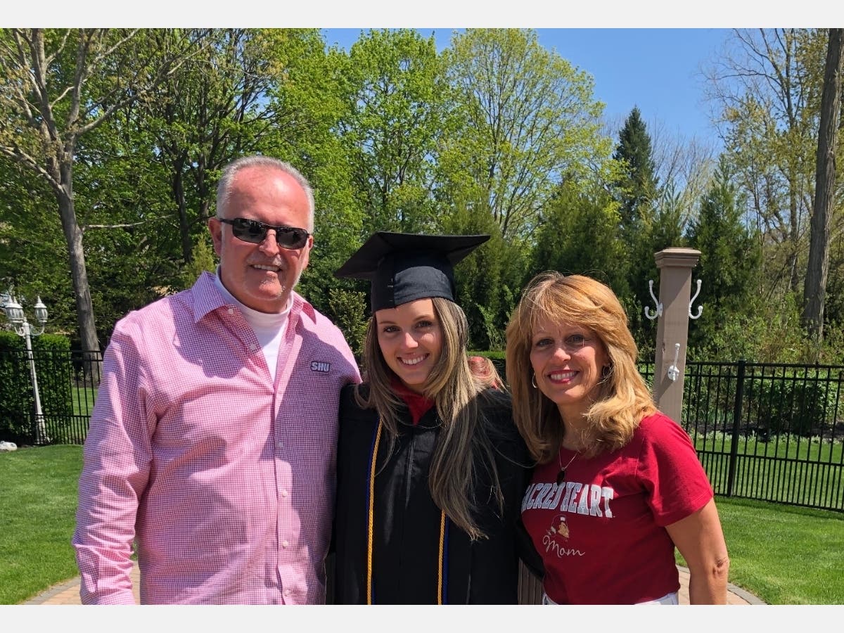 Carly Doorhy and her parents Darla and Joe, outside their Mattituck home as friends celebrated what would have been her college graduation day.