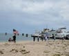 Supporters waving flags on the beach at Orient Point.