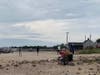 Supporters turned out to the beach at Orient Point with flags and binoculars.
