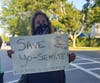 Protesters carried signs in Southampton Saturday.