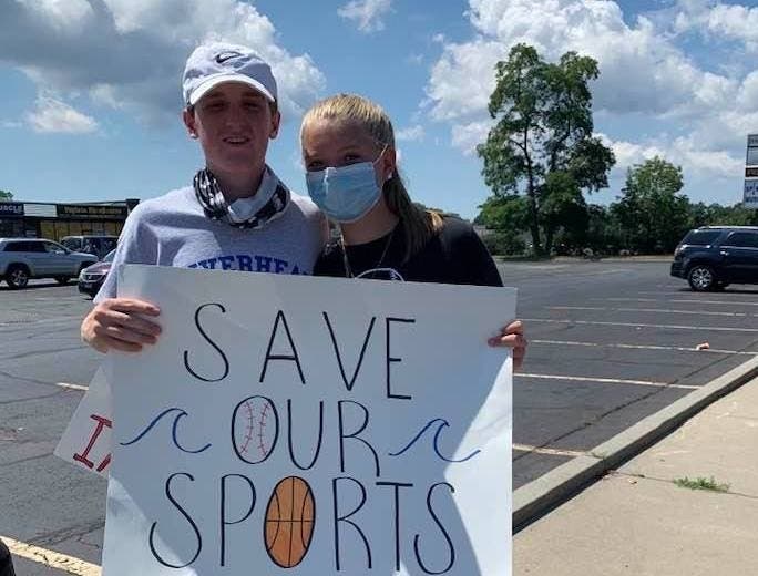 Andrew MacGray and Madison Williams at a rally to save programs.