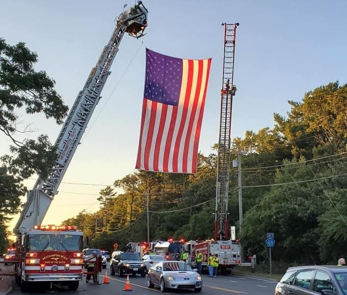 A flag flying high and sirens sounding, family, first responders and friends joined together to welcome George and Mary home to their final resting place.