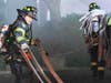 Firefighter Reilly Bean (left) and Ex-captain Tom Glover laying hose.