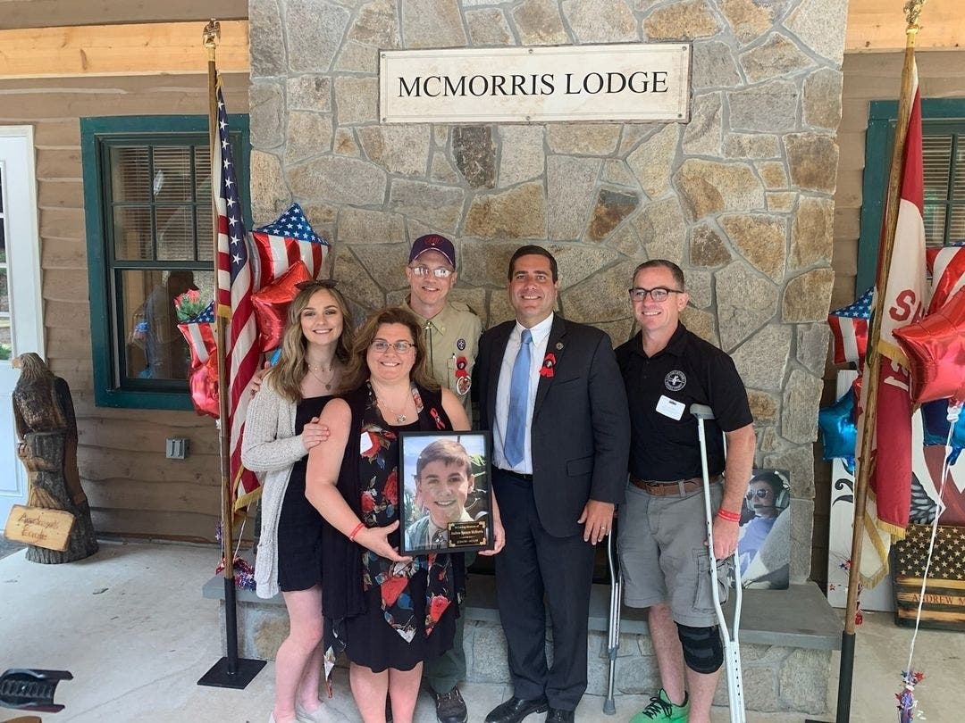 Suffolk County District Attorney Tim Sini along with John, Alisa and Arianna McMorris at a dedication of the McMorris Lodge at the Baiting Hollow Scout Camp in honor of Andrew McMorris, who died after being struck by a drunk driver.