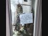 Signs, urging customers to "stay safe" were placed in the windows of shuttered shops in Westhampton Beach.
